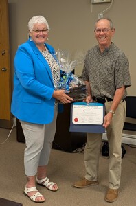 Volunteer at Tee Lake - 30+ years
Mayor Anne Giardini presenting a certificate and gift basket to Raymond Fischer